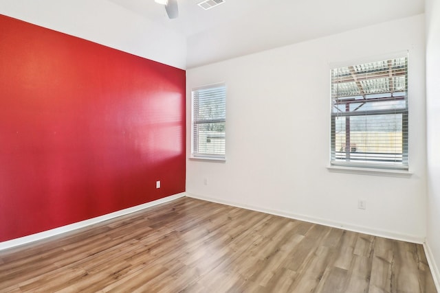 empty room featuring wood-type flooring and ceiling fan