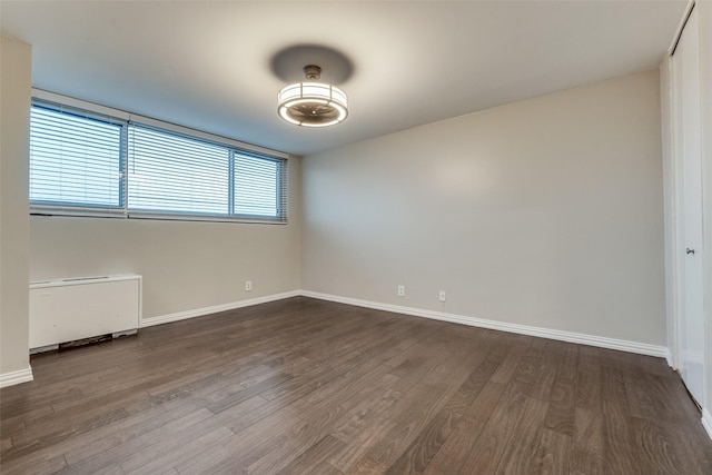 empty room featuring dark hardwood / wood-style floors