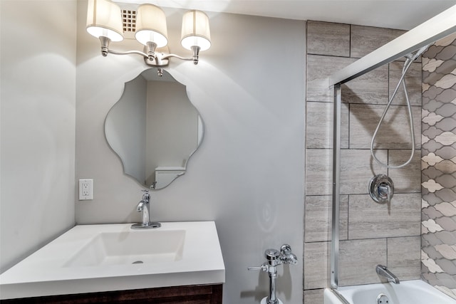 bathroom with vanity and bath / shower combo with glass door