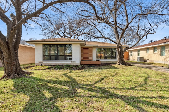 rear view of property with a yard