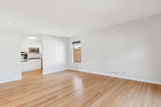 unfurnished living room featuring light hardwood / wood-style floors