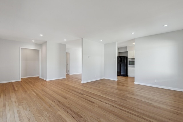 unfurnished living room with light hardwood / wood-style flooring