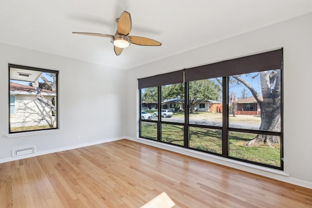 spare room with ceiling fan and light wood-type flooring