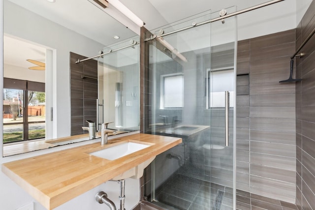 bathroom featuring sink and an enclosed shower