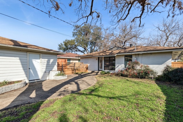 rear view of property with a patio area and a lawn