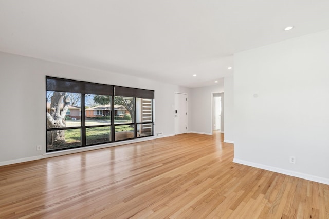 empty room with light hardwood / wood-style flooring