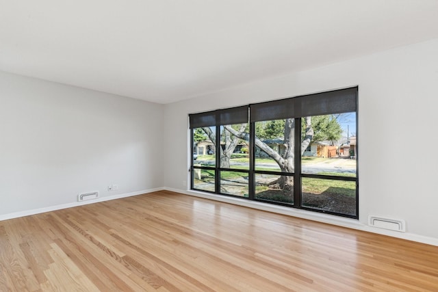 empty room with light hardwood / wood-style floors