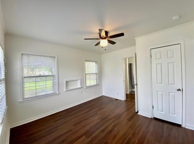 unfurnished bedroom with dark hardwood / wood-style floors and ceiling fan