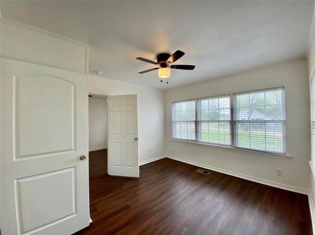 unfurnished bedroom featuring dark wood-type flooring and ceiling fan