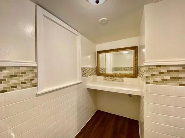 bathroom featuring tile walls and hardwood / wood-style flooring