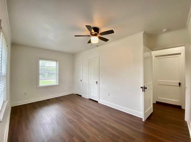 unfurnished bedroom featuring dark wood-type flooring and ceiling fan