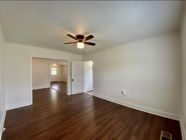 empty room with ceiling fan and dark hardwood / wood-style flooring