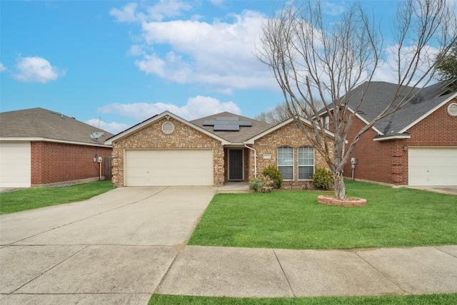 view of front of house featuring a garage, a front yard, and solar panels