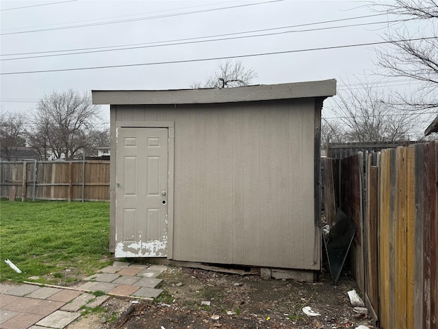 view of outbuilding featuring a yard