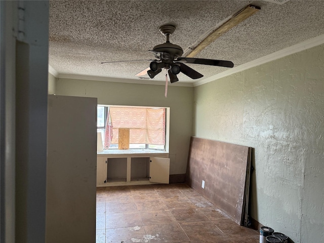 empty room featuring ornamental molding, ceiling fan, and a textured ceiling