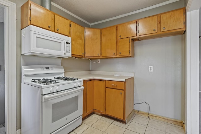 kitchen featuring light tile patterned flooring, crown molding, a textured ceiling, and white appliances