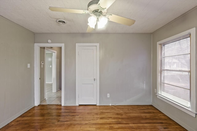 spare room featuring ceiling fan and hardwood / wood-style floors