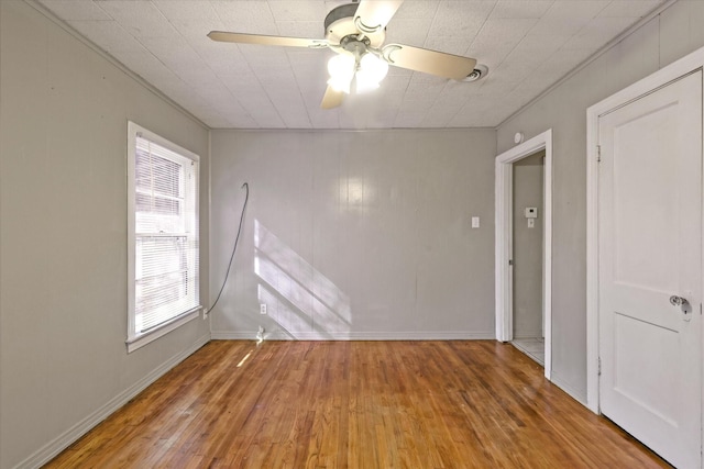 empty room featuring hardwood / wood-style floors and ceiling fan