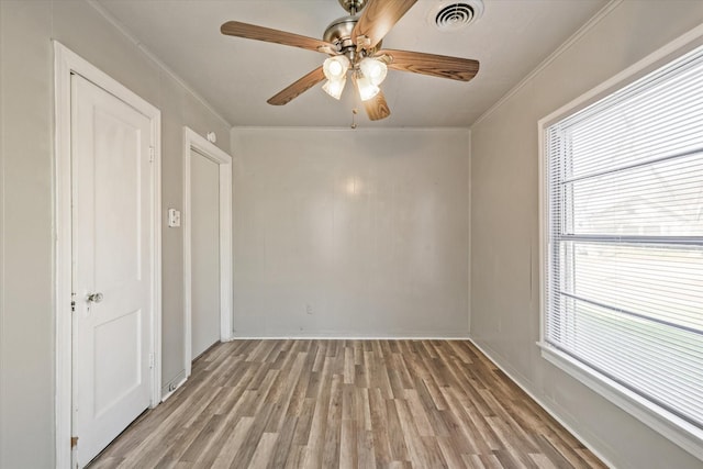 unfurnished room with crown molding, ceiling fan, and light hardwood / wood-style flooring