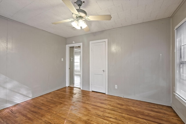 unfurnished room featuring hardwood / wood-style floors and ceiling fan