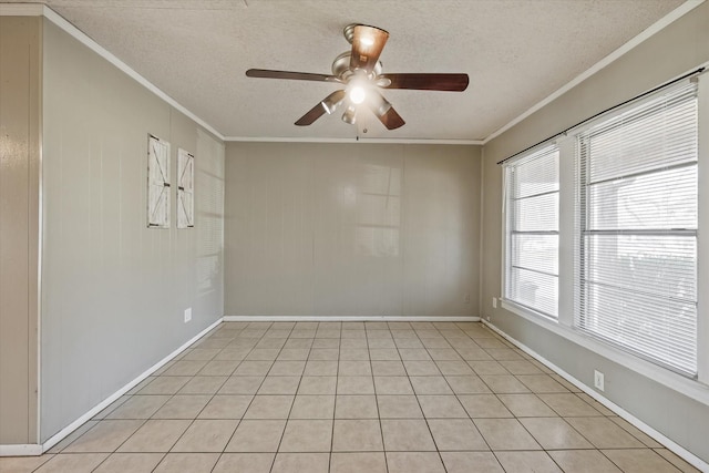 spare room featuring ornamental molding, ceiling fan, and a textured ceiling