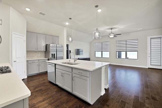 kitchen with an island with sink, appliances with stainless steel finishes, gray cabinets, and sink