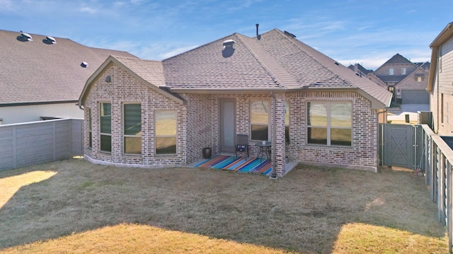 rear view of property with a lawn