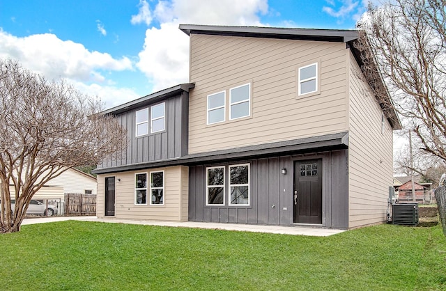 back of property with central AC, a yard, and a patio