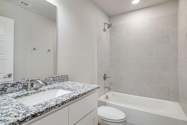 full bathroom featuring vanity, toilet, and tiled shower / bath