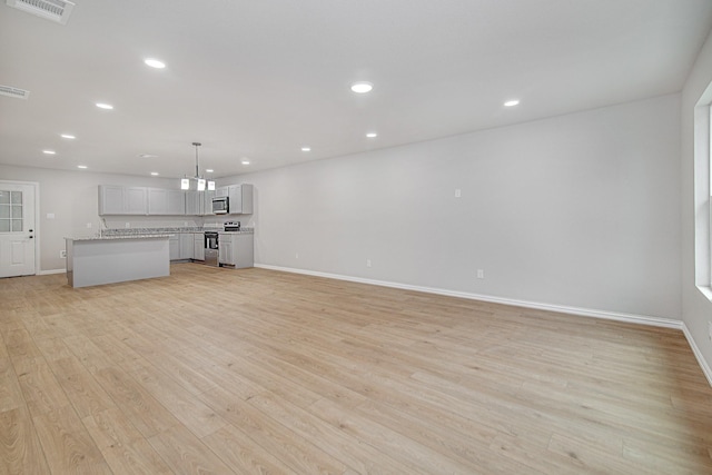 unfurnished living room featuring light hardwood / wood-style floors