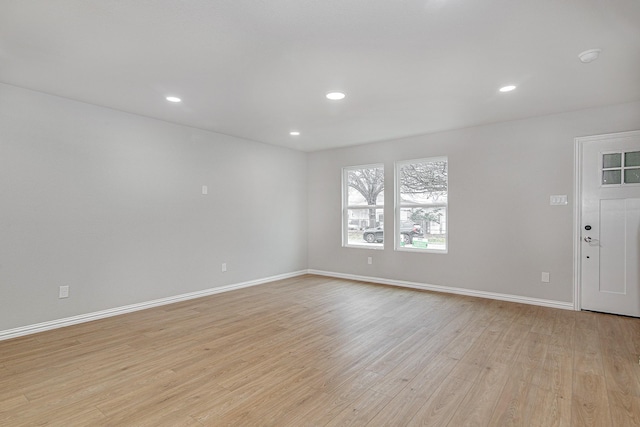 empty room with light hardwood / wood-style flooring