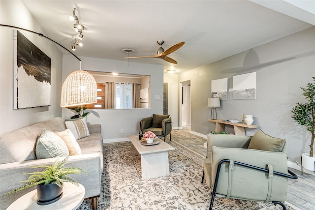 living room featuring ceiling fan and light hardwood / wood-style floors