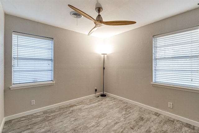 spare room with ceiling fan and light wood-type flooring