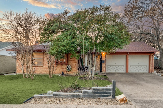 view of front of property featuring a garage and a lawn