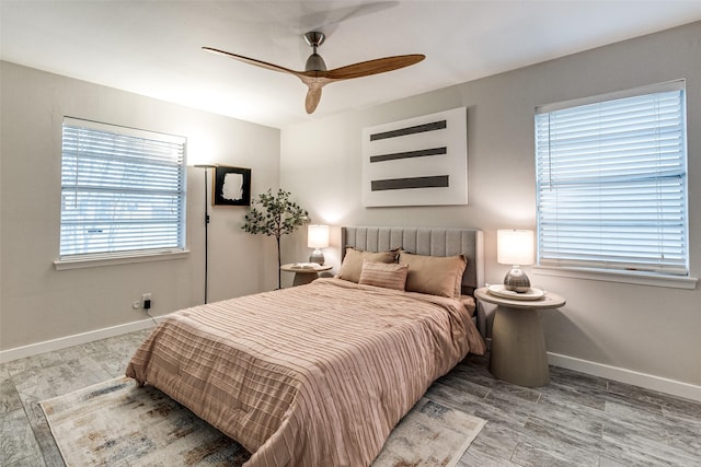 bedroom with ceiling fan and light hardwood / wood-style flooring