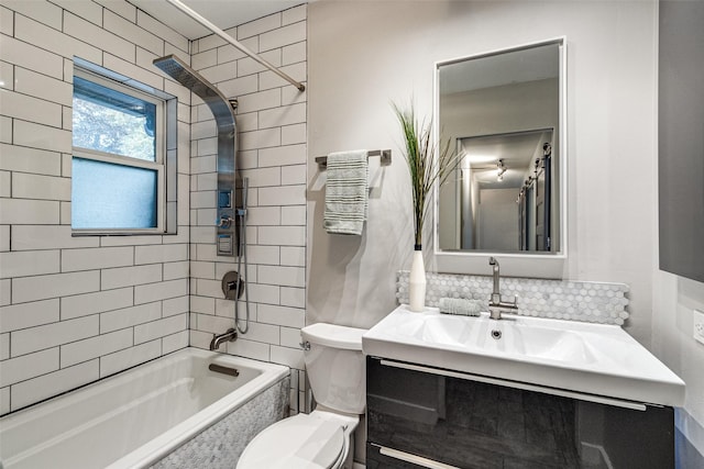 full bathroom with tasteful backsplash, tiled shower / bath, vanity, and toilet