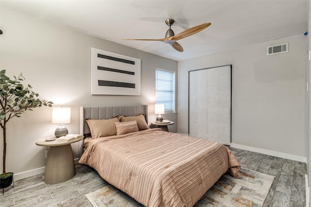 bedroom featuring wood-type flooring, a closet, and ceiling fan