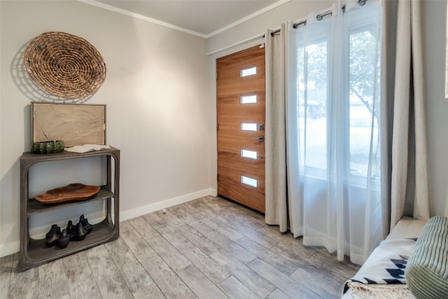 entryway featuring crown molding and light wood-type flooring