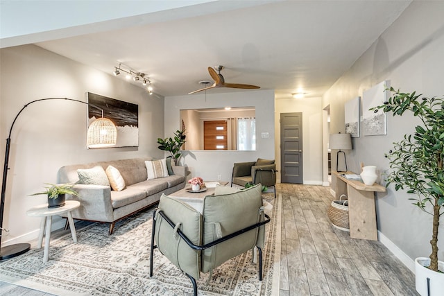 living room with hardwood / wood-style floors and ceiling fan