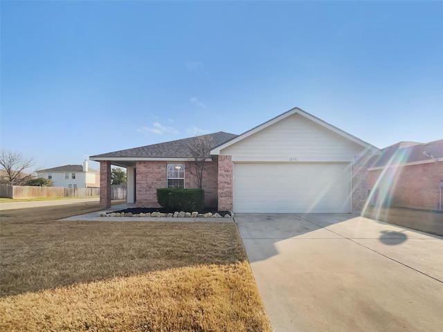 ranch-style home with a garage and a front yard