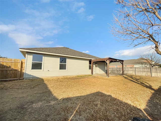 rear view of house with a lawn