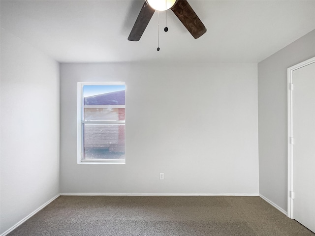 empty room featuring ceiling fan and carpet flooring