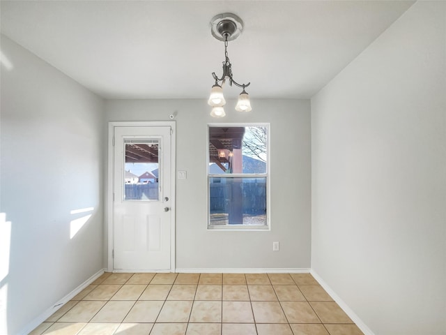 unfurnished dining area featuring an inviting chandelier