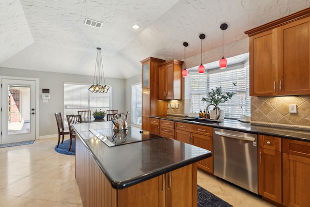 kitchen with a kitchen island, sink, hanging light fixtures, stainless steel dishwasher, and black electric cooktop