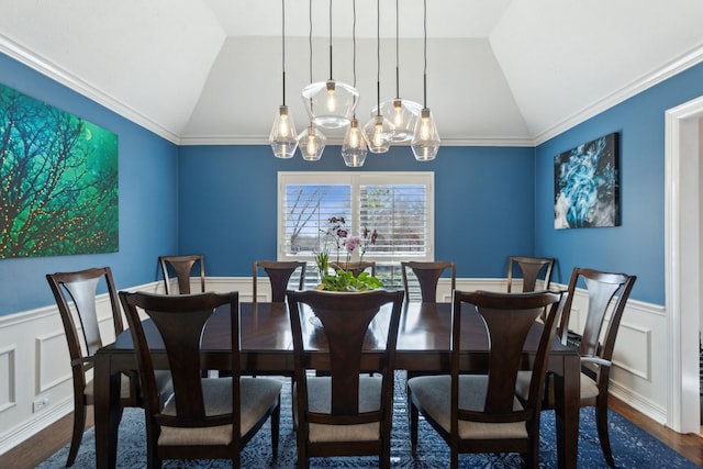 dining room with hardwood / wood-style floors, vaulted ceiling, and a chandelier