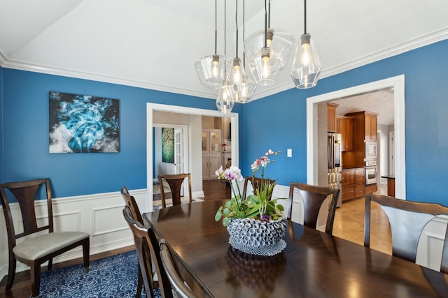 dining space with crown molding and lofted ceiling