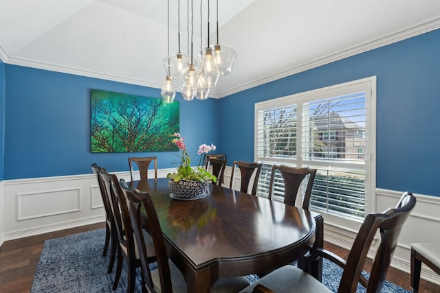 dining area with ornamental molding, dark hardwood / wood-style floors, and a chandelier