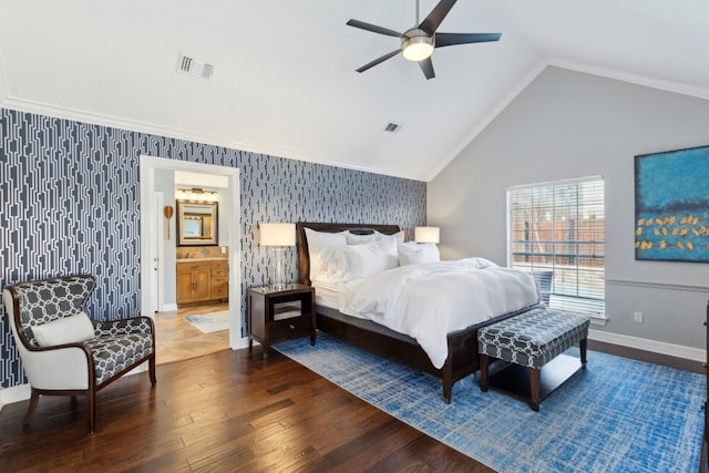 bedroom featuring crown molding, ensuite bath, ceiling fan, dark hardwood / wood-style floors, and vaulted ceiling