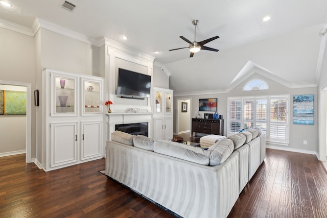 living room featuring dark wood-type flooring, ornamental molding, ceiling fan, and vaulted ceiling