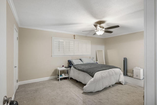 bedroom with ceiling fan, ornamental molding, light colored carpet, and a textured ceiling